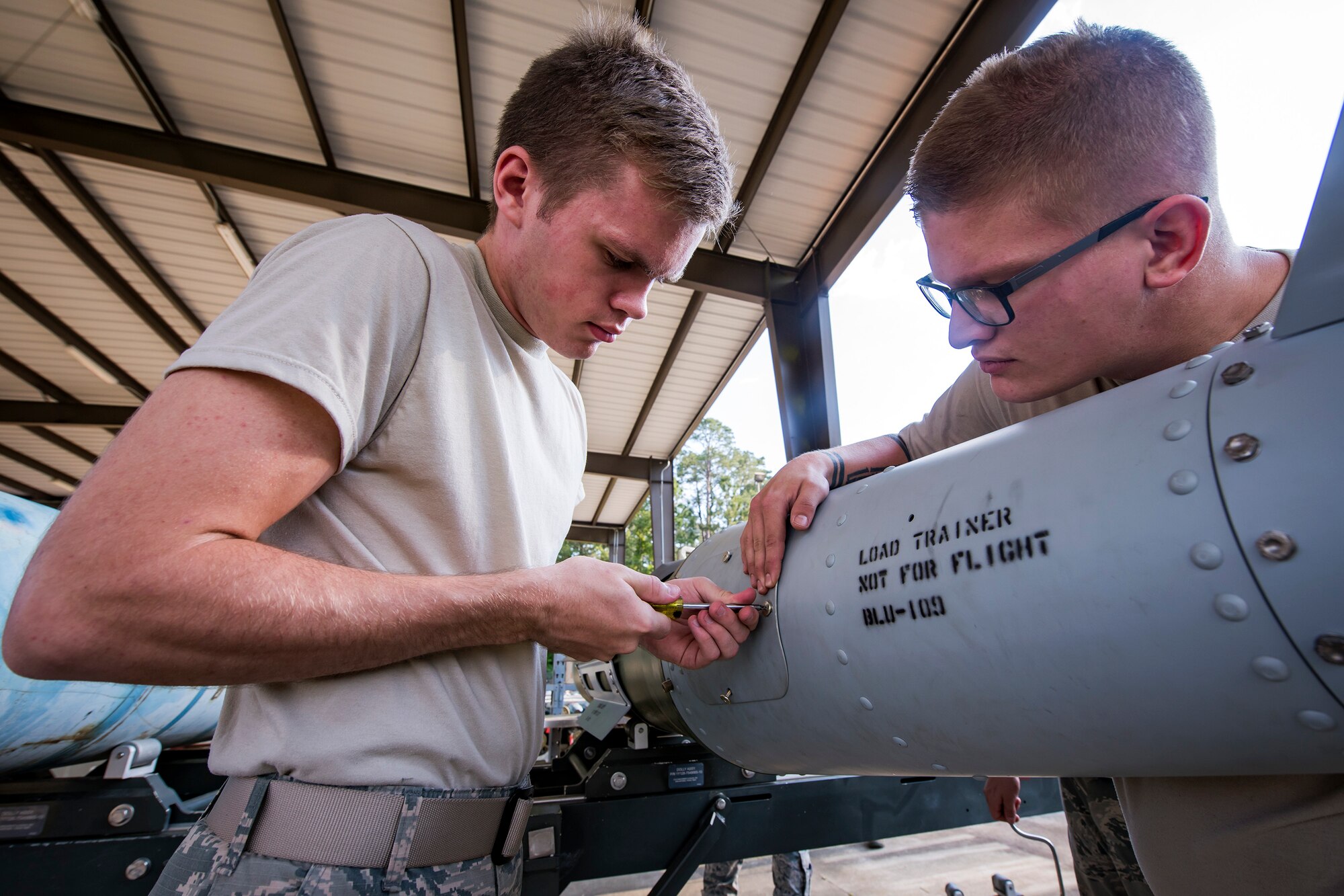 Airman 1st Class Hunter Westerlund, 23d Maintenance Squadron munitions specialist, screws a panel to a Joint-Direct Attack Munition (JDAM) during a bomb building course, May 10, 2018, at Moody Air Force Base, Ga.  To ensure readiness to complete their mission efficiently, Airmen practiced constructing a JDAM while wearing Mission Oriented Protective Posture gear to further simulate what their mission could entail. (U.S. Air Force photo by Airman 1st Class Eugene Oliver)