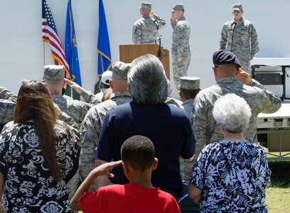 Attendees honor the U.S. flag as the national anthem is sung at the Joint Base San Antonio Airman Leadership School naming ceremony at JBSA-Lackland, Texas, May 11, 2018. The school was named in honor of Staff Sgt. Cierra Rogers, an alumnus, who died May 20, 2016, from injuries sustained after saving a family from a burning building April 29, 2016. (U.S. Air Force photo by Tech. Sgt. R.J. Biermann)