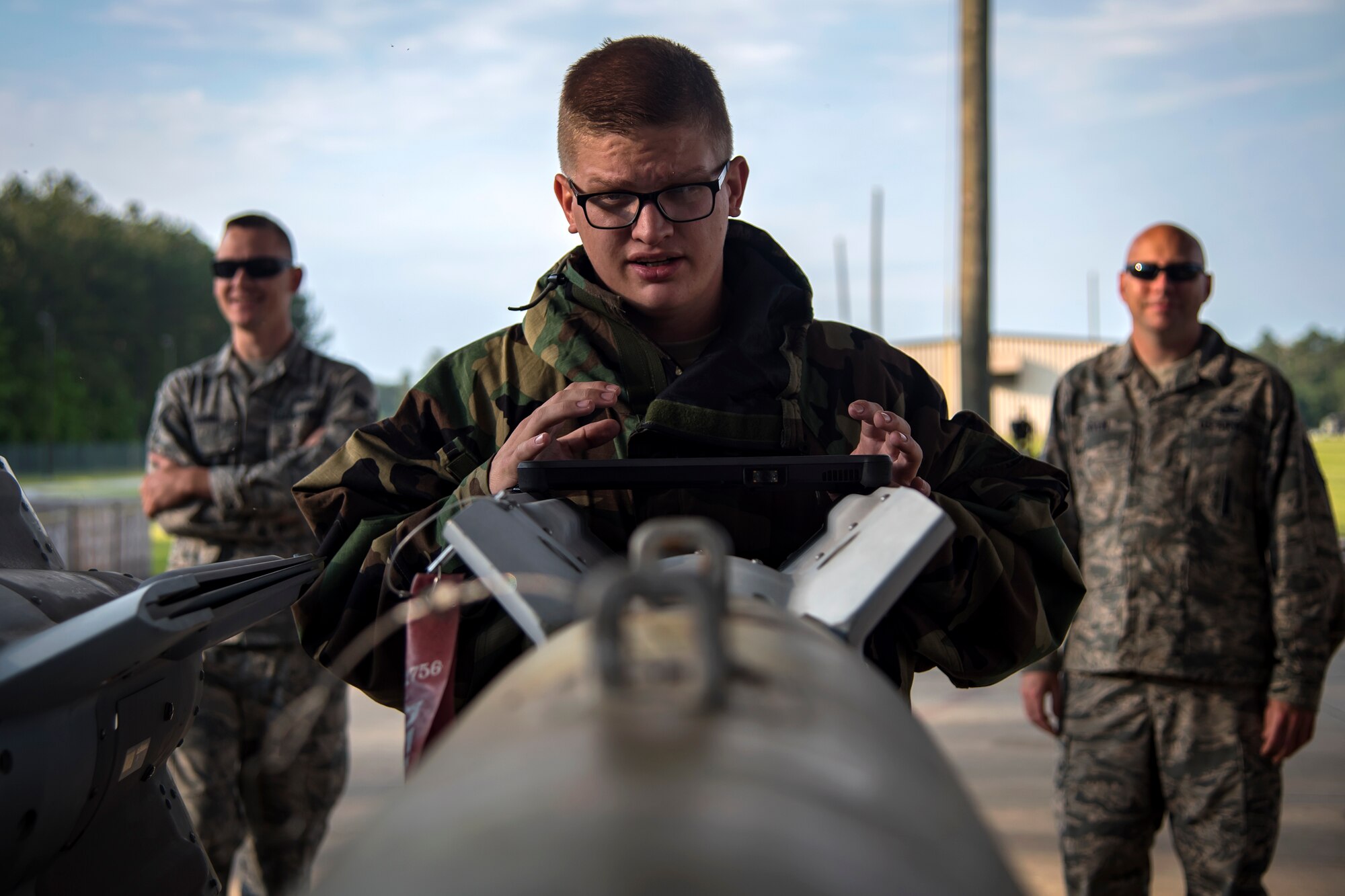 Senior Airman Joshua Hamilton, 23d Maintenance Squadron munitions crew chief, inspects the alignment of a Joint Direct Attack Munition (JDAM) during a bomb building course, May 10, 2018, at Moody Air Force Base, Ga. To ensure readiness to complete their mission efficiently, Airmen practiced constructing a JDAM while wearing Mission Oriented Protective Posture gear to further simulate what their mission could entail. (U.S. Air Force photo by Airman 1st Class Eugene Oliver)