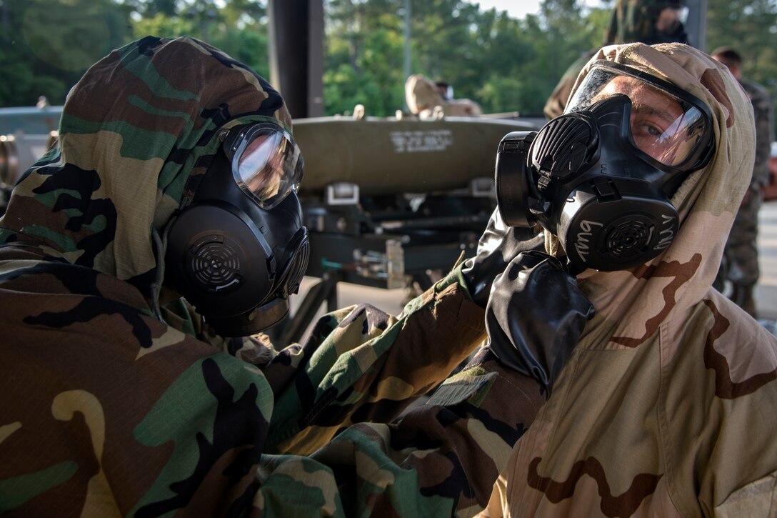 Airman 1st Class Makyle Judd, left, 23d Maintenance Squadron trailer maintenance specialist, inspects the equipment on Airman 1st Class Joshua Sandy, 23d MXS munitions systems specialist, May 10, 2018, at Moody Air Force Base, Ga. (U.S. Air Force photo by Airman 1st Class Eugene Oliver)
