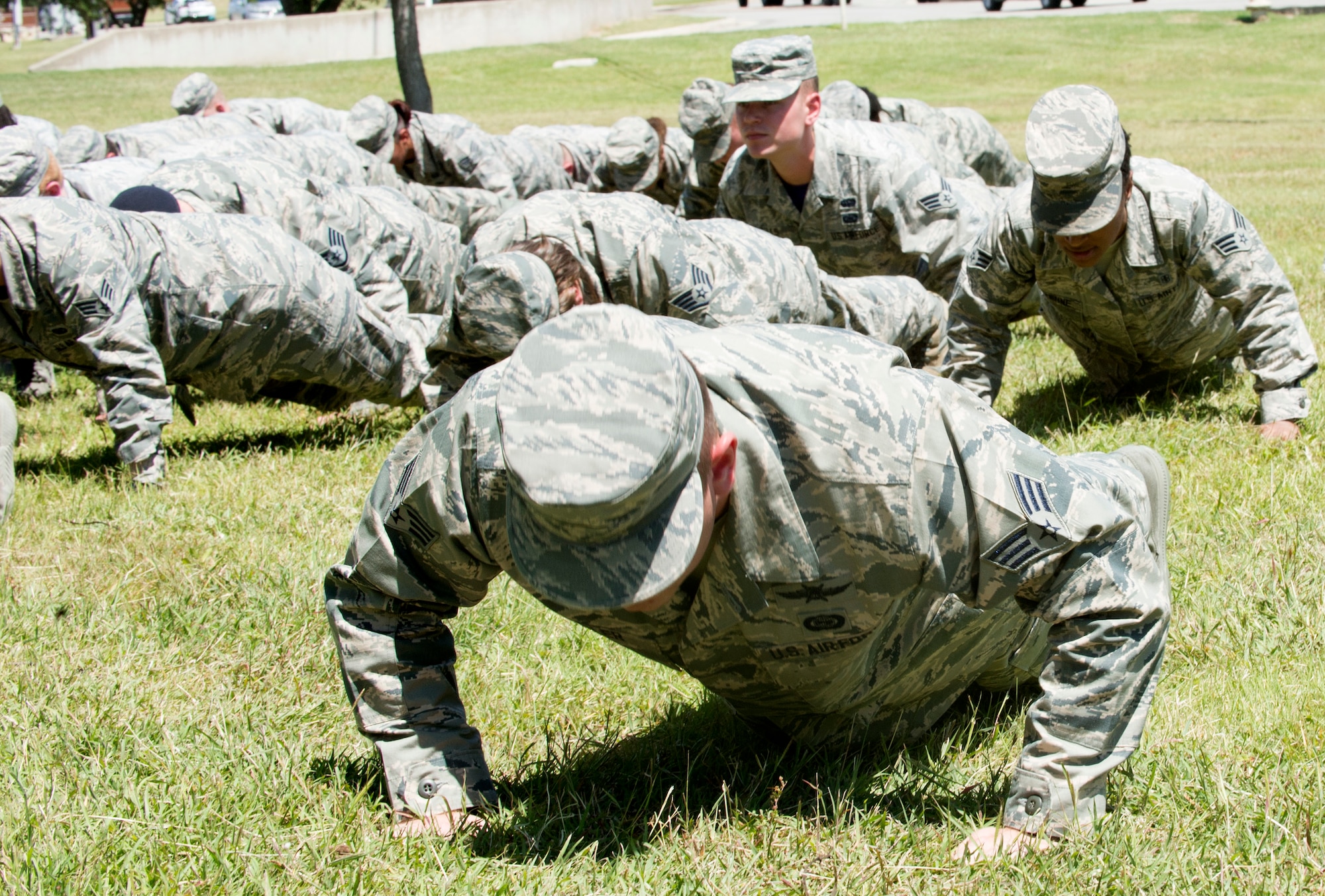 Airmen perform memorial pushups during the Joint Base San Antonio Airman Leadership School naming ceremony at JBSA-Lackland, Texas, May 11, 2018. The school was named in honor of Staff Sgt. Cierra Rogers, an alumnus, who died May 20, 2016 from injuries sustained after saving a family from a burning building April 29, 2016. (U.S. Air Force photo by Tech. Sgt. R.J. Biermann)