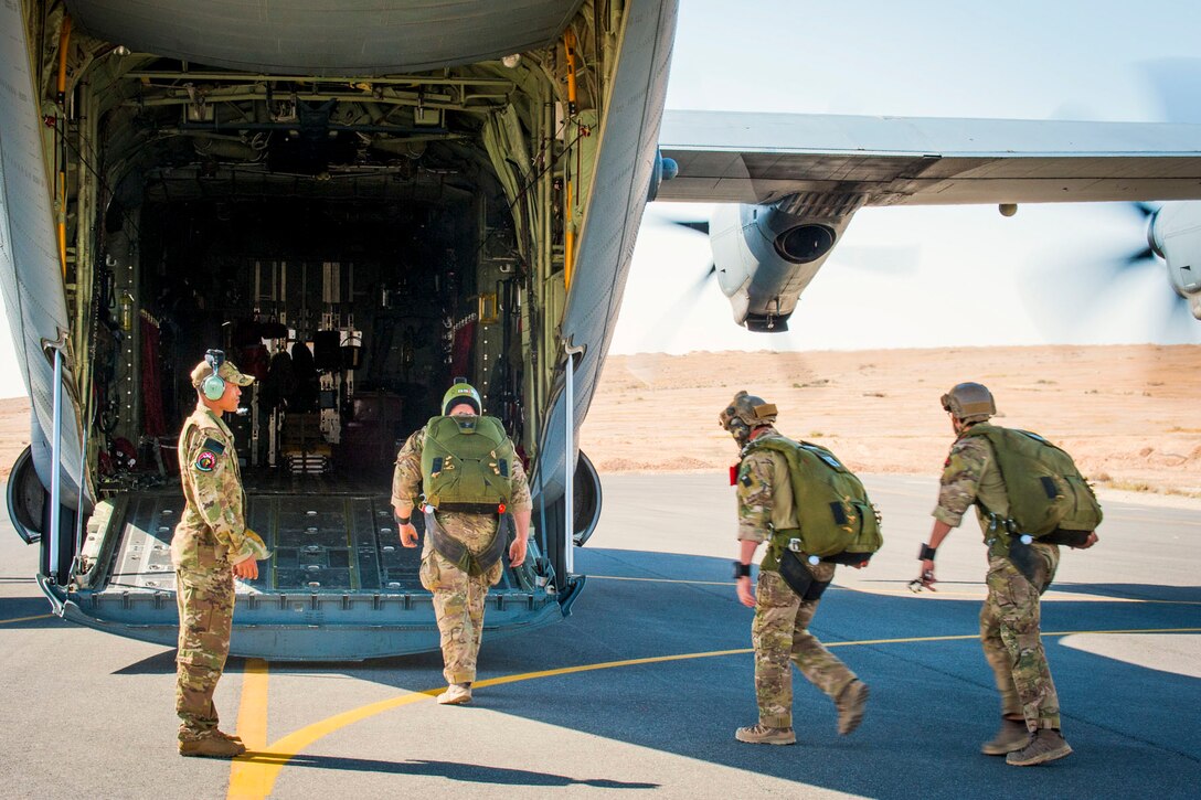 U.S. Air Force Reserve Staff Sgt. Anthony Miller, a loadmaster assigned to the 327th Airlift Squadron, 913th Airlift Group, waits as U.S. Marine Corps Special Forces members load into the back of a C-130J Super Hercules for a parachute exercise April 15, 2018.