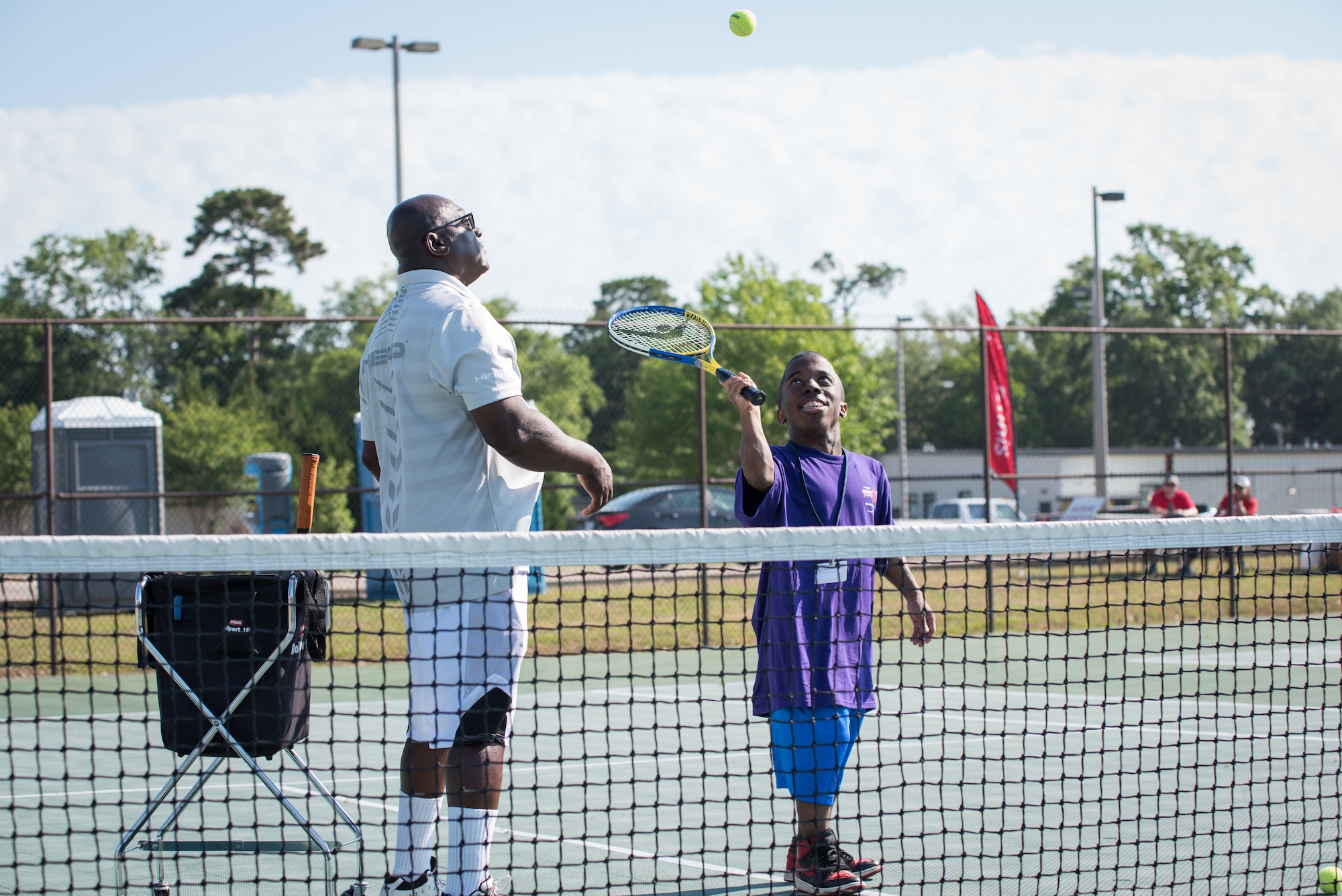 Henry Harris, Special Olympics Mississippi tennis director, tosses a ball to Shaquille Williams, Area 7 athlete, during the Special Olympics Mississippi 2018 Summer Games at the tennis courts at Keesler Air Force Base, Mississippi, May 12, 2018. Founded in 1968, Special Olympics hosts sporting events around the world for people of all ages with special needs to include more than 700 athletes from Mississippi. (U.S. Air Force photo by Andre' Askew)