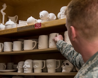 Air Force Staff Sgt. Patrick Dean, 3rd Munitions Squadron conventional maintenance crew chief, picks up a ceramic at the Polar Express Arts and Crafts Center as part of an Initial Supervisor Resiliency Training bus tour at Joint Base Elmendorf-Richardson, Alaska, May 10, 2018. The tour is a new Pacific Air Forces-wide initiative for all ALS graduates, which offers an opportunity to see and interact with the programs and resources discussed during the course.