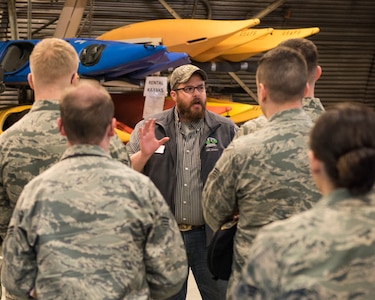 Tyler Glen, Outdoor Recreation director, speaks to speaks to Airman Leadership School graduates at Joint Base Elmendorf-Richardson, Alaska, May 10, 2018. The graduates took part in a new Pacific Air Forces-wide initiative for all ALS graduates to reinforce information obtained in Initial Supervisor Resiliency Training. At the forefront of this initiative is a bus tour the day after graduation, which offers an opportunity to see and interact with the programs and resources discussed during the course.