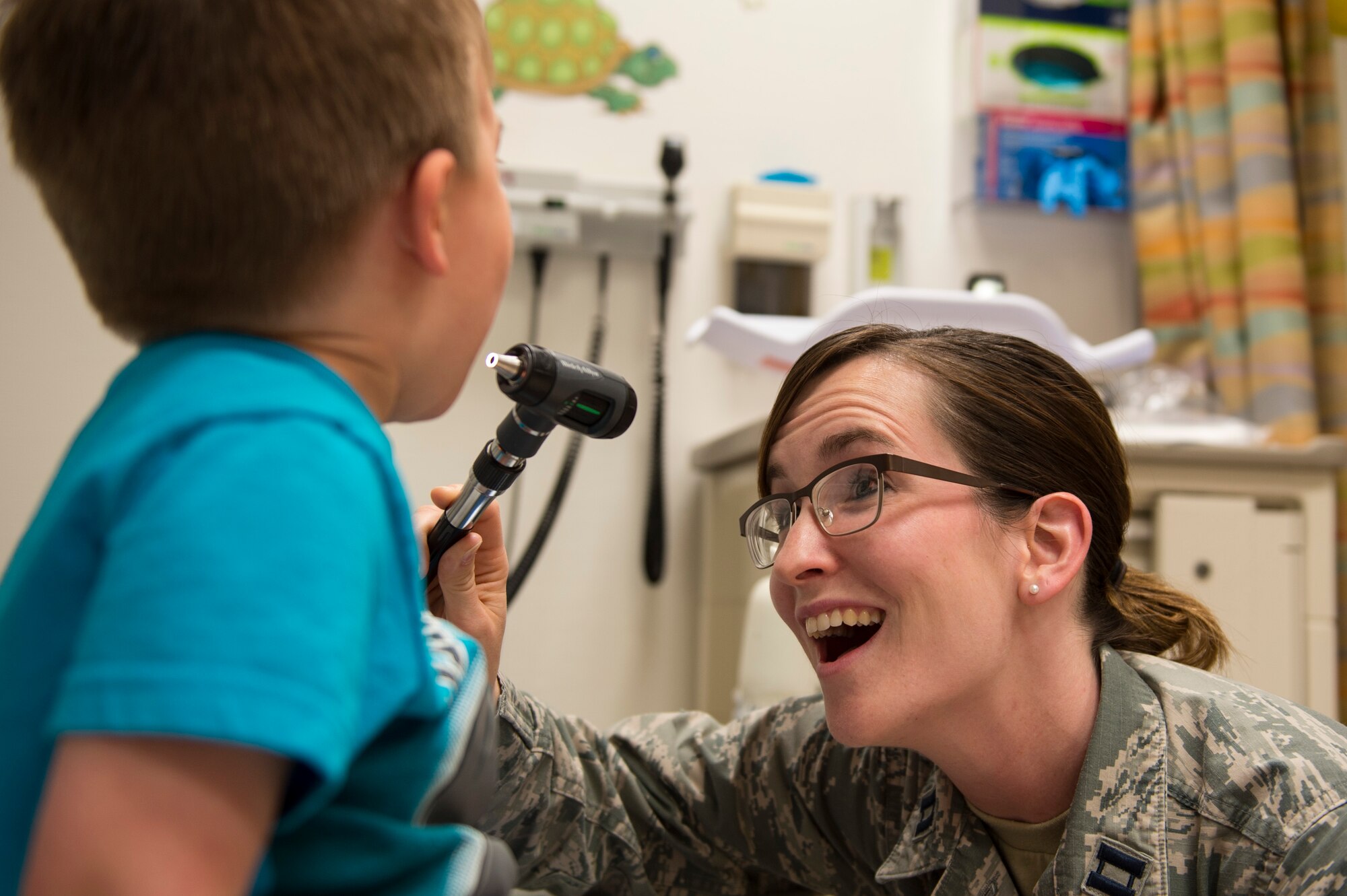 U.S. Air Force Capt. Heather Bezerra, 52nd Medical Operations Squadron pediatric nurse, prepares to examine James, 3, son of Senior Airman Dawn Weber, 52nd Fighter Wing photojournalist, at Spangdahlem Air Base, Germany, May 10, 2018. (U.S. Air Force photo by Senior Airman Dawn M. Weber)