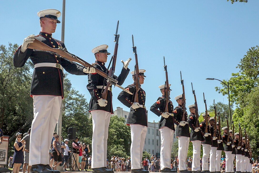 Marines use weapons to preform a routine.