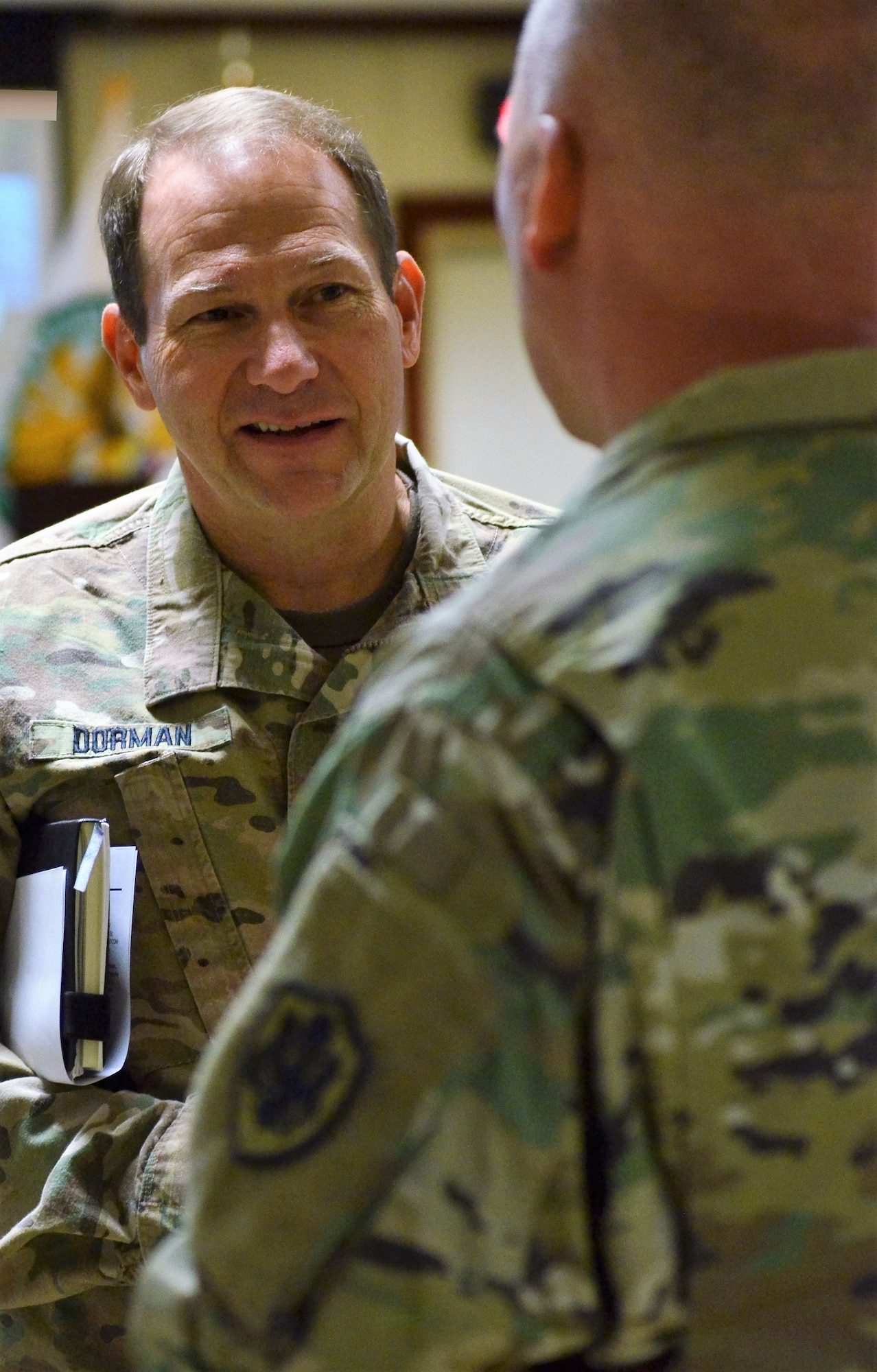 U.S. Army Major General Edward Dorman, Director of Logistics and Engineering for U.S. Central Command, speaks with a fellow logistician at the Joint Logistics Coordination Board at Al Udeid Air Base, Qatar on 9 May, 2018. Dorman urged participants to stay focused on sustaining the fight and setting the theater as a means to support military operations. (U.S. Air Force photo by Senior Airman Patrick Wyatt