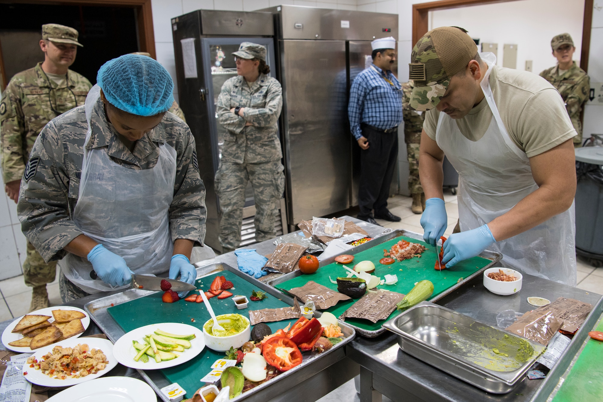 Contestants in the "Chopped on the Rock" competition chop vegetables at an undisclosed location in Southwest Asia, May 9, 2018. Five 386th Expeditionary Force Support Squadron Airmen competed in the 30 minute competition. (U.S. Air Force photo by Staff Sgt. Joshua King)