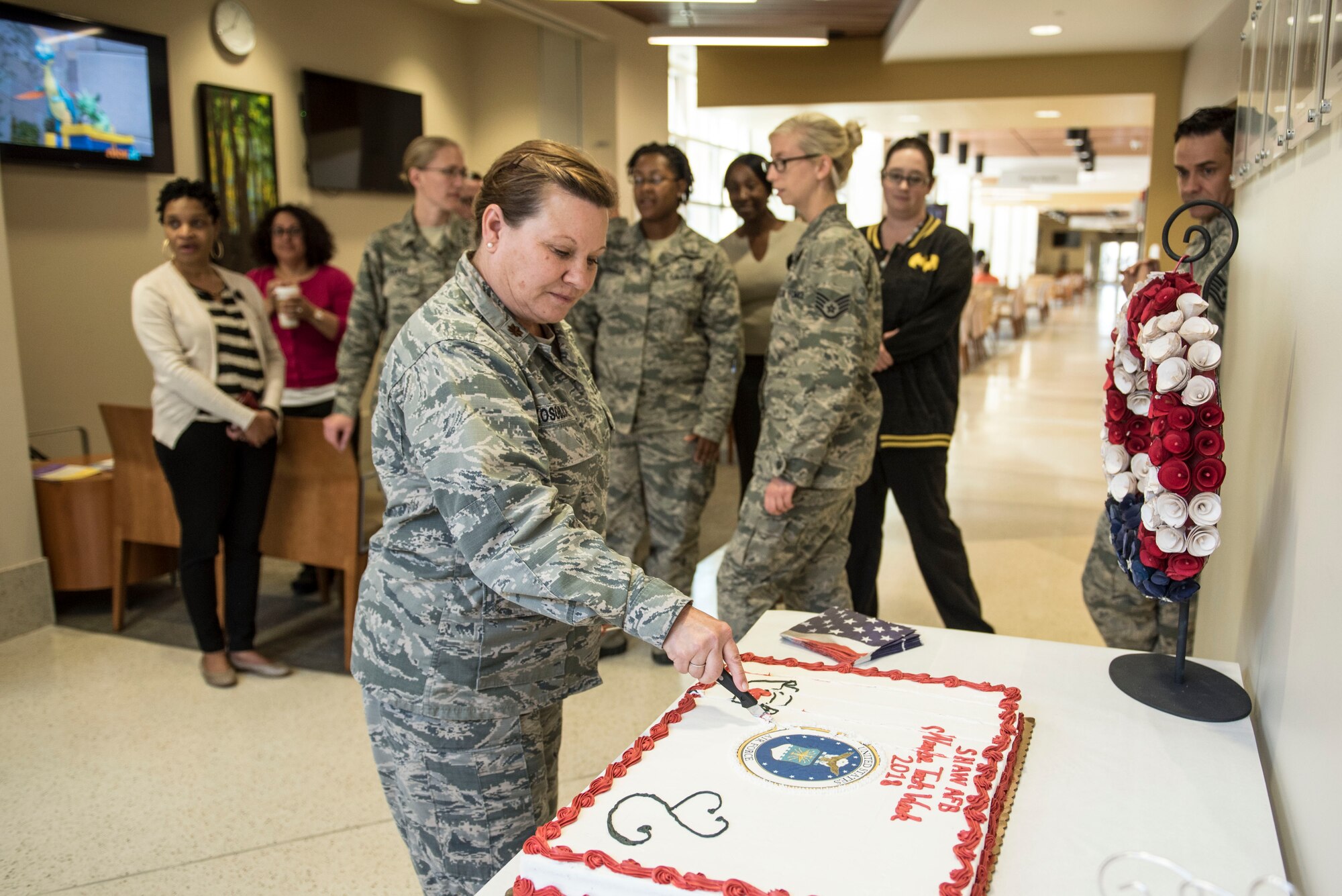 U.S. Airmen assigned to the 20th Medical Group (MDG) gather in the clinic atrium for a cake-cutting ceremony at Shaw Air Force Base, S.C., May 9, 2018.