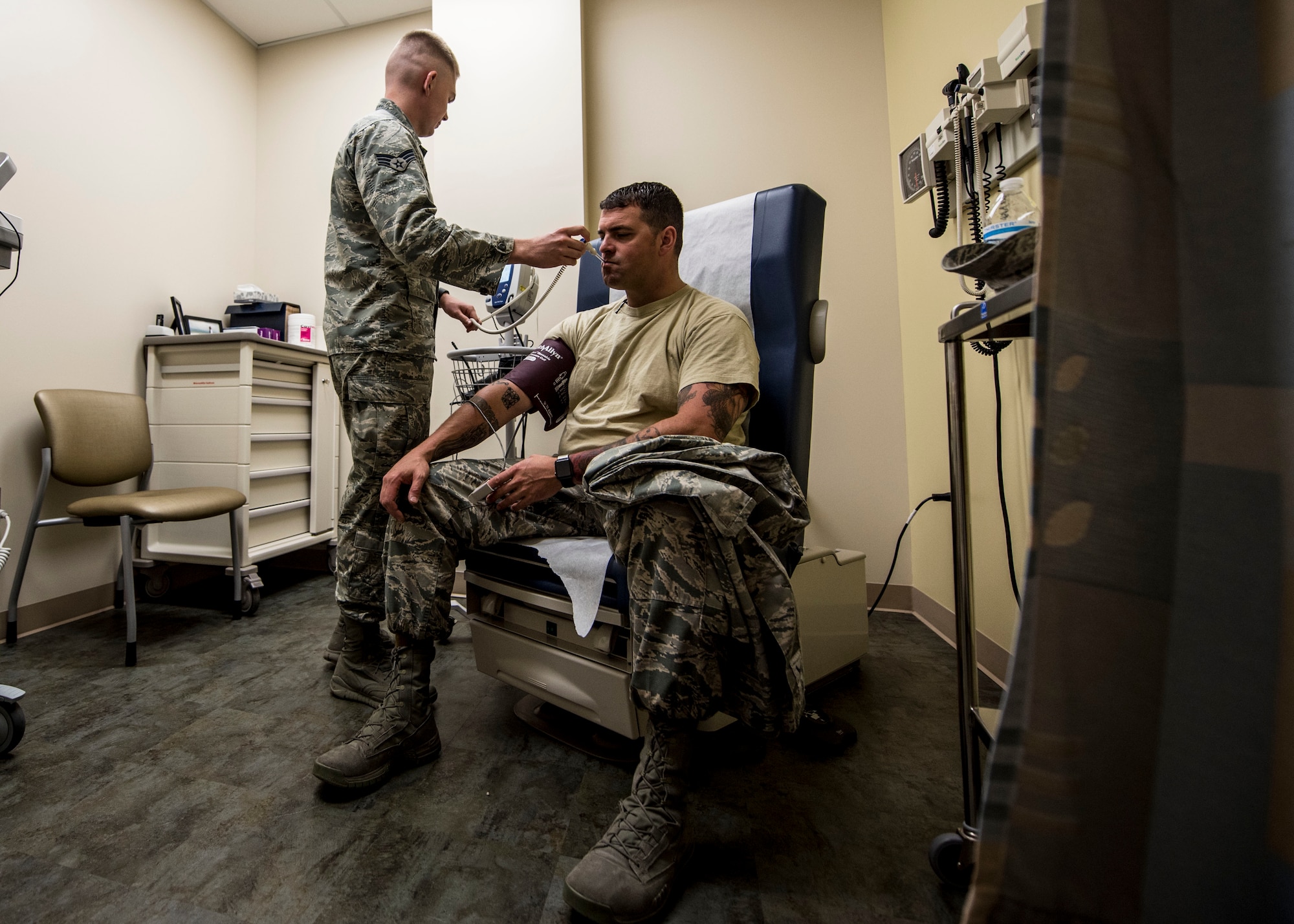 U.S. Air Force Senior Airman Christopher Aubuchon, 20th Medical Operations Squadron aerospace medical technician, left, takes the vitals of a patient at Shaw Air Force Base, S.C., May 10, 2018.