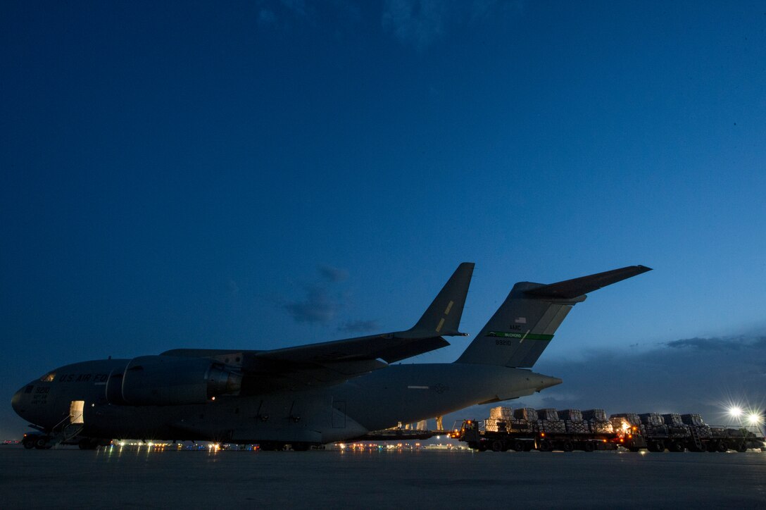 U.S. Air Force loadmasters assigned to the 816th Expeditionary Airlift Squadron and air transportation personnel load pallets onto a C-17 Globemaster III at Bagram Air Field, Afghanistan, May 10, 2018. The C-17 transported troops and cargo to forward operating locations throughout the U.S. Central Command area of responsibility in support of Operation Freedom Sentinel mission. The C-17 is not only proficient in transporting troops and supplies, but can also perform tactical airlift and airdrop missions and transport ambulatory patients during aeromedical evacuations. (U.S. Air Force photo by Staff Sgt. Keith James)