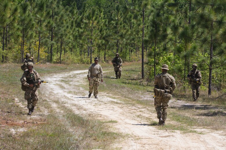 Soldiers from the Royal Bermuda Regiment patrol as part of the Junior Noncommissioned Officer Cadre on Marine Corps Base Camp Lejeune, N.C., May 4, 2018. The JNCO Cadre is a promotions course for promotion from Private Bandsman Drummer to Lance Corporal and is open to all soldiers who have completed one year of service and have the recommendation of their company commander. This training requires additional drill nights and weekends and develops leadership, command skills, military knowledge and strengthens teamwork. (U.S. Marine Corps photo by Cpl. Juan Madrigal)