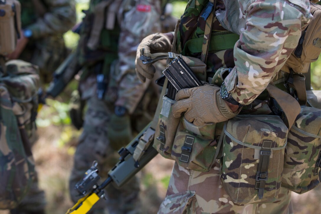 Soldiers from the Royal Bermuda Regiment ready themselves for scenario based exercises during the Junior Noncommissioned Officer Cadre on Marine Corps Base Camp Lejeune, N.C., May 4, 2018. The JNCO Cadre is a promotions course for promotion from Private Bandsman Drummer to Lance Corporal and is open to all soldiers who have completed one year of service and have the recommendation of their company commander. This training requires additional drill nights and weekends and develops leadership, command skills, military knowledge and strengthens teamwork. (U.S. Marine Corps photo by Cpl. Juan Madrigal)