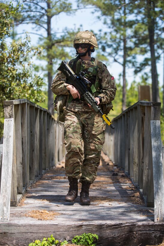 A Soldier from the Royal Bermuda Regiment crosses a wooden bridge at the Junior Non-commissioned Officer Cadre on Marine Corps Base Camp Lejeune, N.C., May 4, 2018. The JNCO Cadre is a promotions course for promotion from Private Bandsman Drummer to Lance Corporal and is open to all Soldiers who have completed one year of service and have the recommendation of their company commander. This training requires additional drill nights and weekends and develops leadership, command skills, military knowledge and strengthens teamwork. (U.S. Marine Corps photo by Cpl. Juan Madrigal)