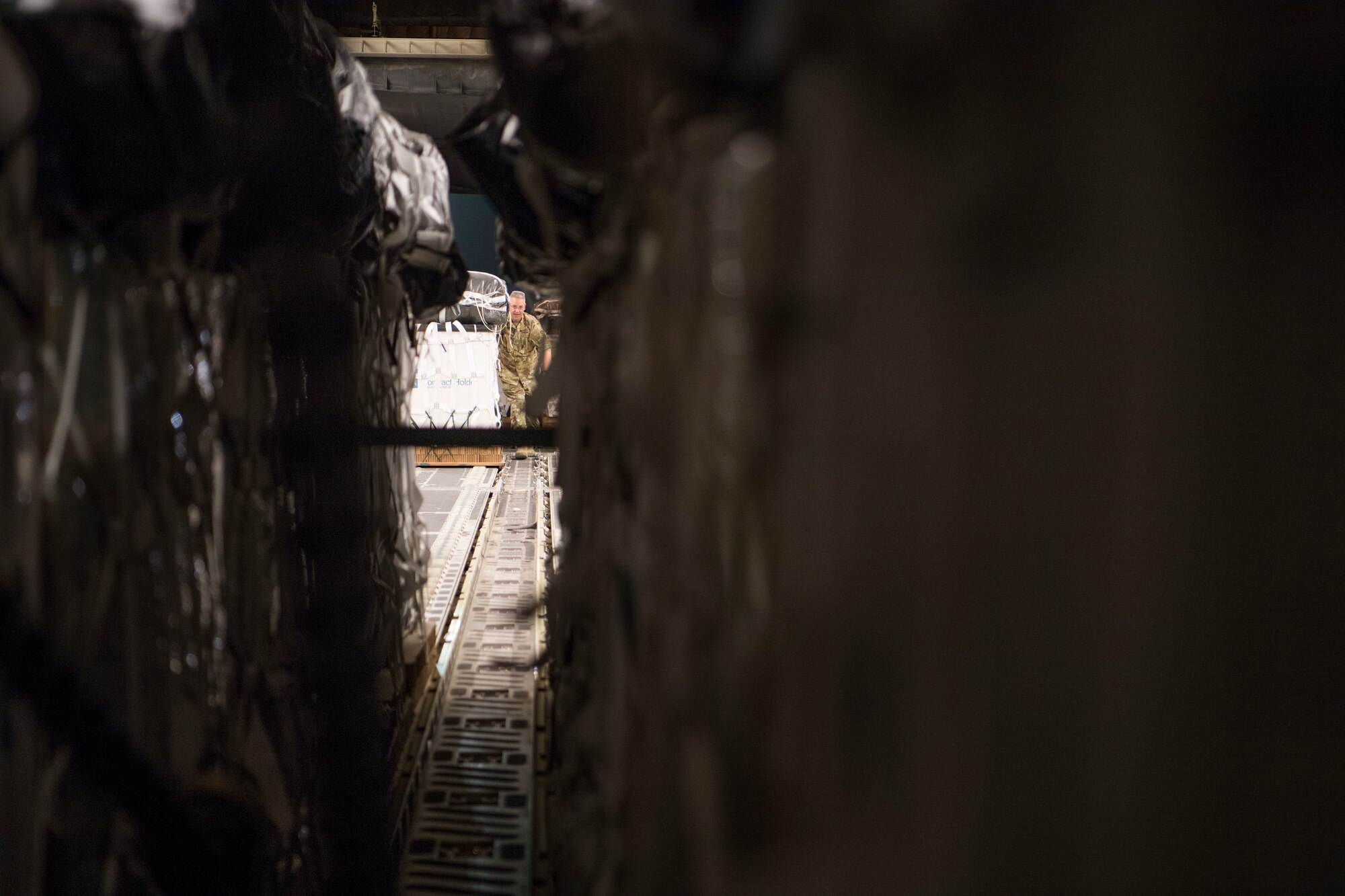 U.S. Air Force Senior Master Sgt. Davin Lammey, 816th Expeditionary Airlift Squadron superintendent, loads a container delivery system bundle onto a C-17 Globemaster III before a airdrop mission at Bagram Airfield, May 10, 2018. The primary mission of the C-17 is to provide rapid strategic delivery of troops and various types of cargo to bases throughout the U.S. Central Command area of responsibility. (U.S. Air Force photo by Staff Sgt. Keith James)