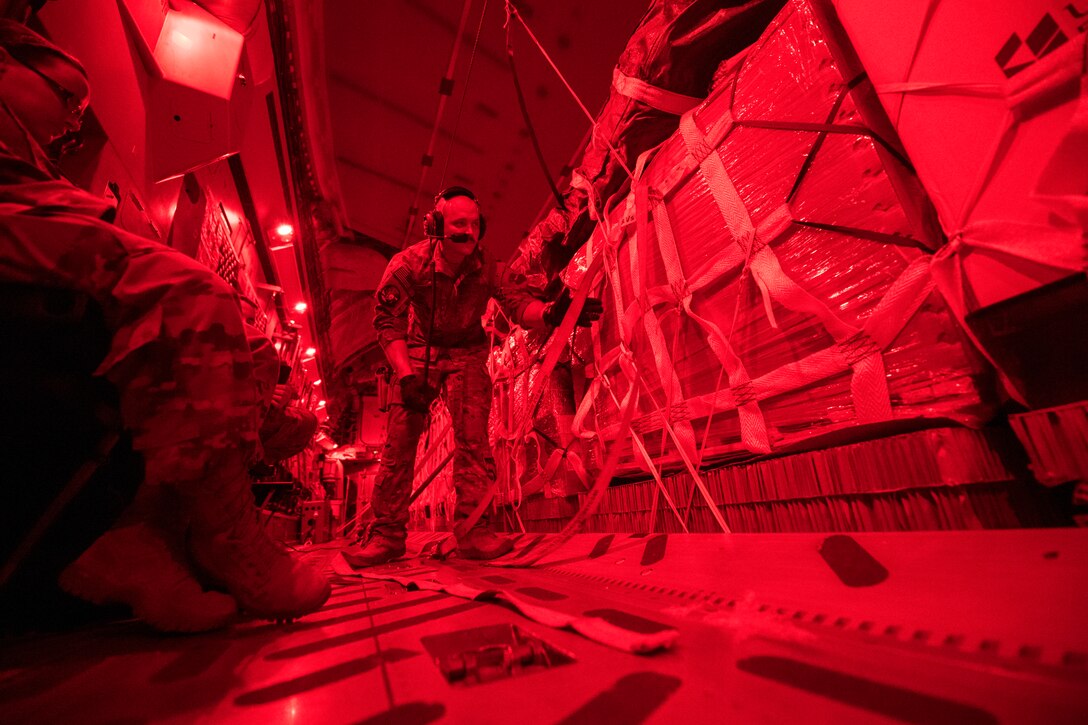 U.S. Air Force Senior Airman Jeremy Kosick, 816th Expeditionary Airlift Squadron instructor loadmaster, checks the cargo straps covering container delivery system bundles on a C-17 Globemaster III before a airdrop over Afghanistan, May 10, 2018. The C-17 transported troops and cargo to forward operating locations throughout the U.S. Central Command area of responsibility in support of Operation Freedom Sentinel mission. The C-17 is not only proficient in transporting troops and supplies, but can also perform tactical airlift and airdrop missions and transport ambulatory patients during aeromedical evacuations.(U.S. Air Force photo by Staff Sgt. Keith James)