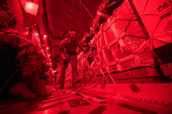 U.S. Air Force Senior Airman Jeremy Kosick, 816th Expeditionary Airlift Squadron instructor loadmaster, checks the cargo straps covering container delivery system bundles on a C-17 Globemaster III before a airdrop over Afghanistan, May 10, 2018. The C-17 transported troops and cargo to forward operating locations throughout the U.S. Central Command area of responsibility in support of Operation Freedom Sentinel mission. The C-17 is not only proficient in transporting troops and supplies, but can also perform tactical airlift and airdrop missions and transport ambulatory patients during aeromedical evacuations.(U.S. Air Force photo by Staff Sgt. Keith James)