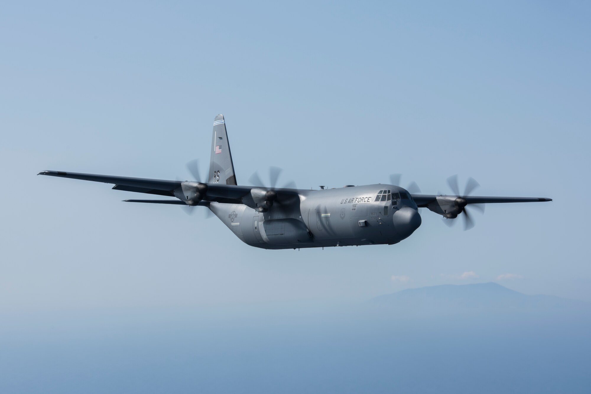 A U.S. Air Force C-130J Super Hercules flies in formation behind a Hellenic air force C-130H Hercules during an exercise Stolen Cerberus V interfly mission near Elefsis Air Base, Greece, May 10, 2018. The two aircraft flew through multiple drop zones and different terrains during the mission. (U.S. Air Force photo by Senior Airman Devin M. Rumbaugh)