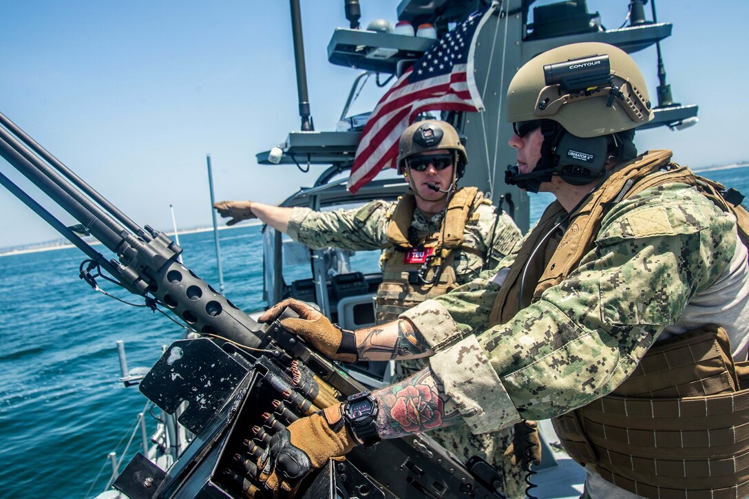 Sailors talk small boat attack exercise tactics.