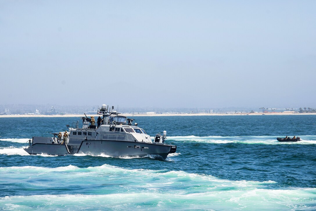 Sailors aboard a patrol boat conduct simulated small boat attack exercise.