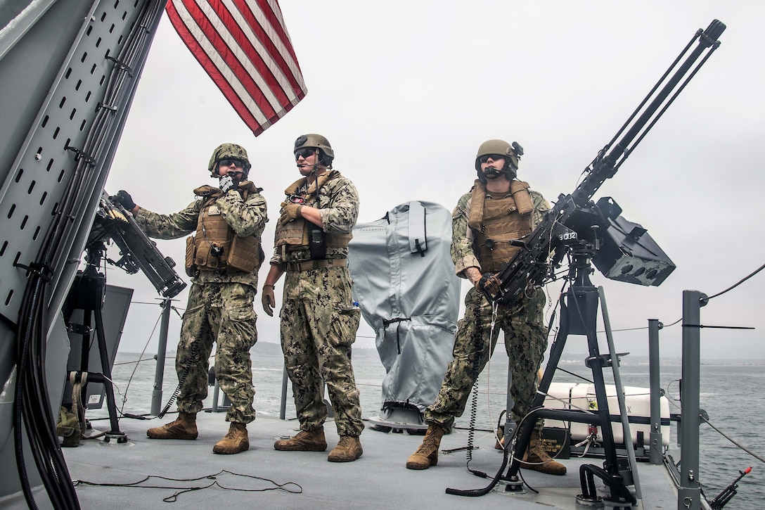 Sailors aboard a patrol boat conduct simulated small boat attack exercise.
