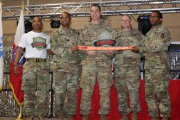 Cyber Protection Team 100, from Fort Gordon, Ga. accepts overall first place trophy for the Best Cyber Ranger Competition, Camp Arifjan, Kuwait, May 10.