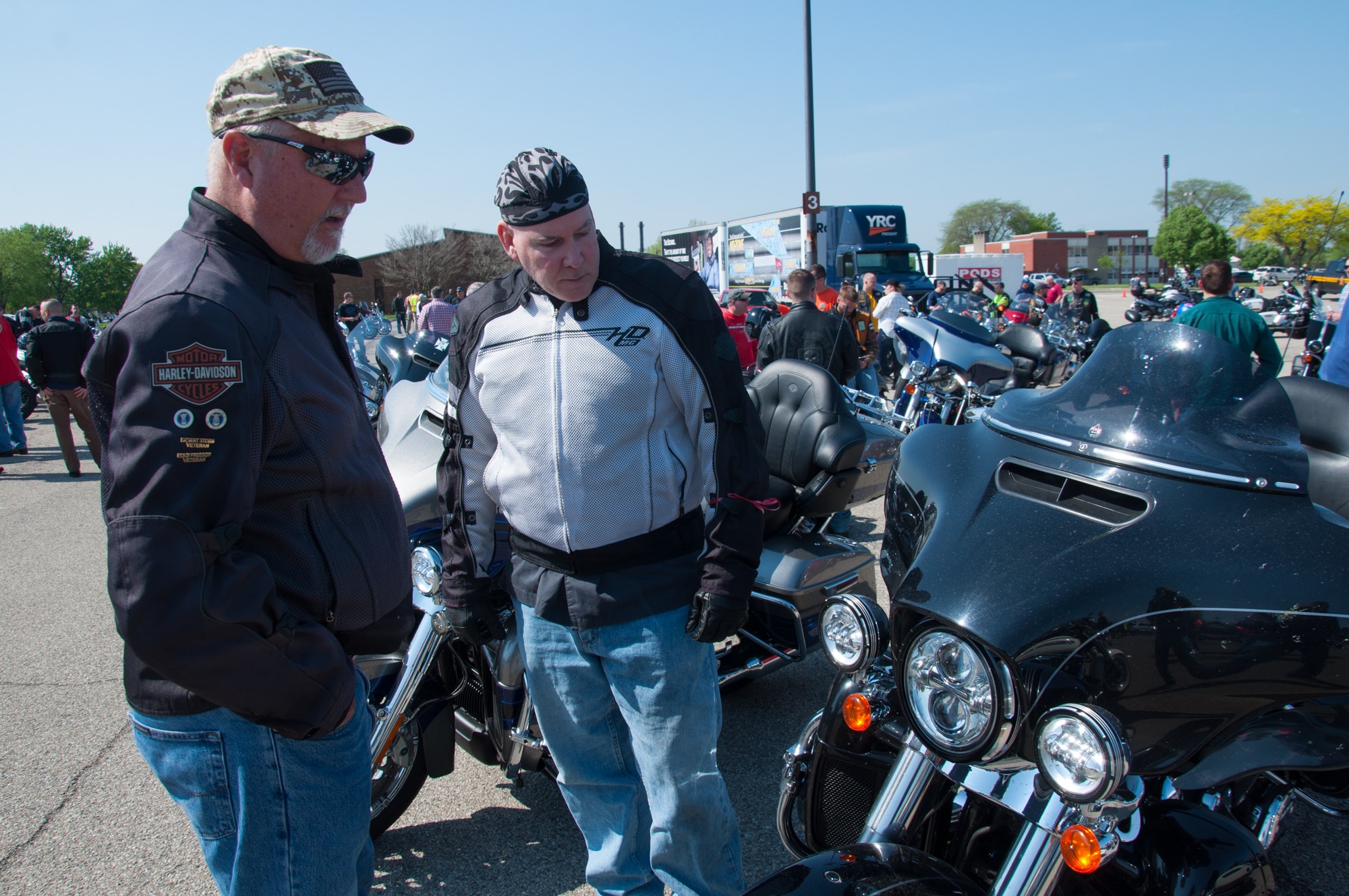 Steven Segebart, Air Force Materiel Command analyst (left) and Michael Summers, a master sergeant with the 445th Airlift Wing, talk bikes at Motorcycle Safety Day May 11, 2018.