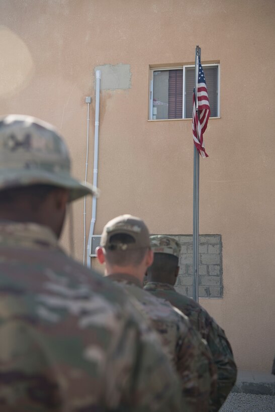 Airmen with the 332nd Air Expeditionary Wing and Soldiers with the 3-2 Air Defense Artillery Unit gather for a retreat ceremony honoring fallen defenders and office of special investigations agents during May 11, 2018, at an undisclosed location in Southwest Asia.