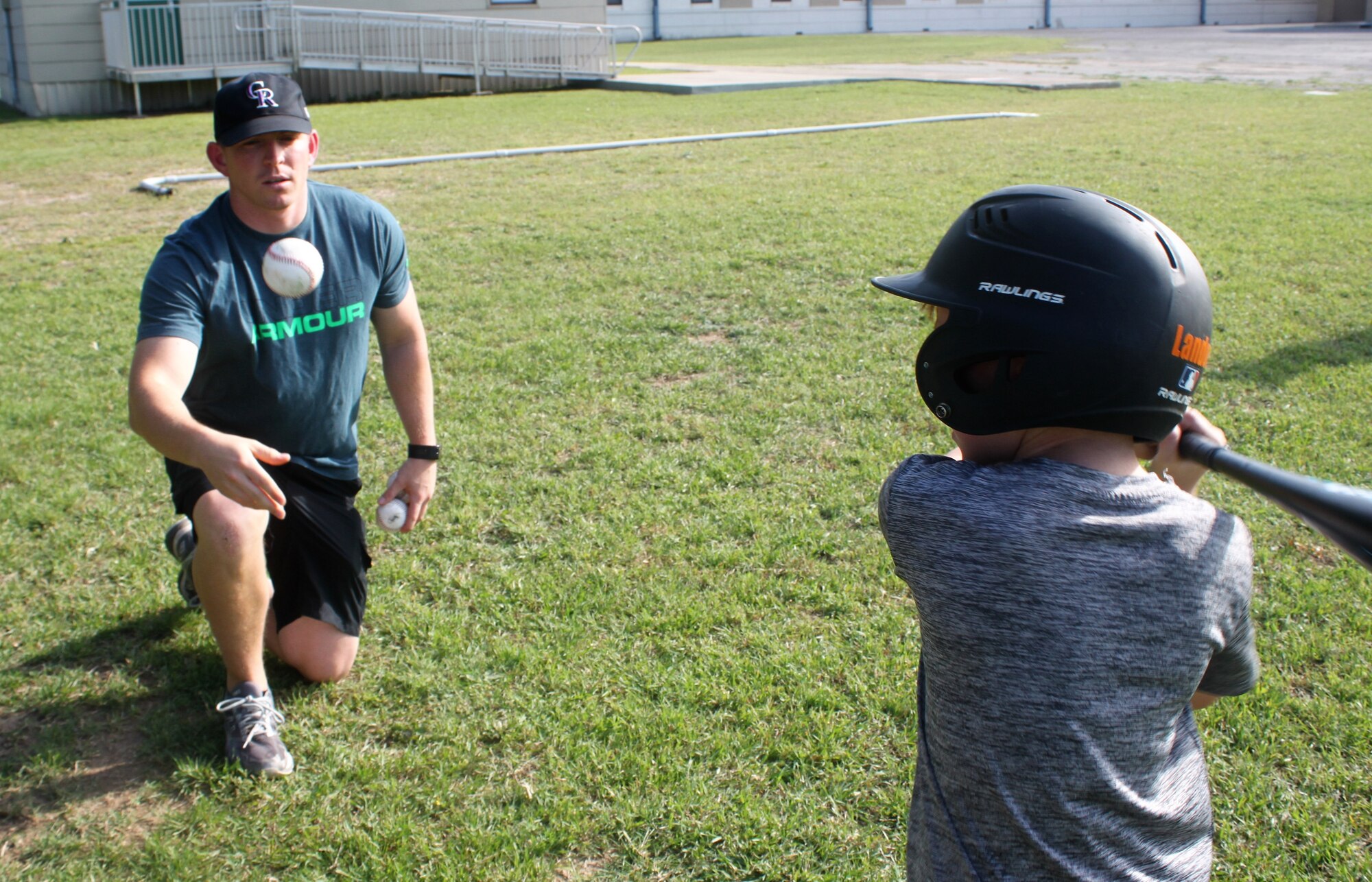 Master Sgt. Randy Alvis works with his son Landon on batting skills during youth baseball practice. Volunteers are the heart of youth sports, Alvis believes. (U.S. Air Force photo by Debbie Gildea)