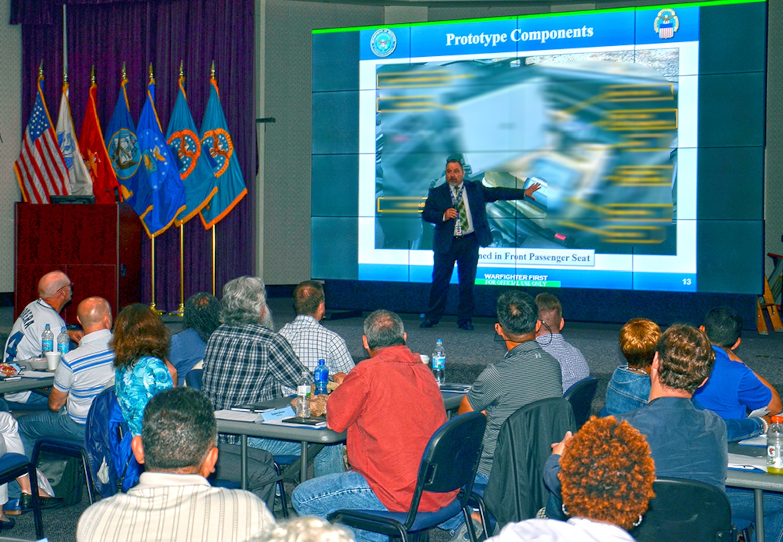 DLA Disposition Services Logistics Management Division Chief Arthur Welsh describes the mobile office concept to Disposal Service Representatives during a customer support workshop in Battle Creek, Michigan, May 15. NOTE: Photo has been partially blurred to protect proprietary third-party technology.