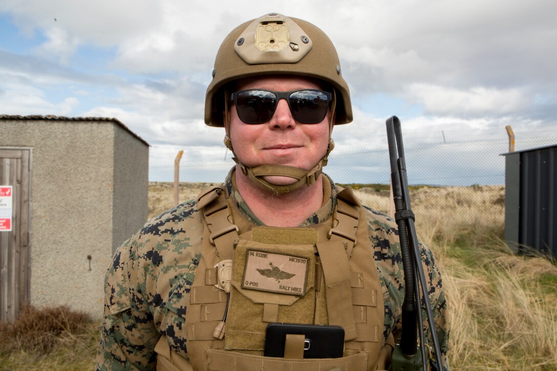 Sgt. Michael Kozik, a firepower control team chief with 4th Air Naval Gunfire Liaison Company, Force Headquarters Group, poses for a photo after an exercise at Tain Firing Range in Tain, Scotland, April 24, 2018.. 4th ANGLICO is in Scotland to take part in Joint Warrior 18-1, an exercise that furthers their readiness and effectiveness in combined arms integration, small unit tactics and land navigation. This training aims at improving their capabilities and combat effectiveness and ensures they're ready to fight tonight.