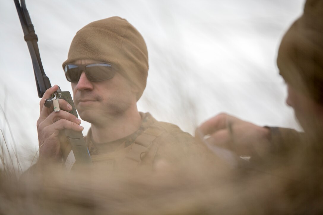Sgt. Michael Peers, a firepower control team chief with 4th Air Naval Gunfire Liaison Company, Force Headquarters Group, calls in a target location during a close air support exercise at the Tain Gunfire Range in Tain, Scotland, April 24, 2018. 4th ANGLICO is in Scotland to take part in Joint Warrior 18-1, an exercise that furthers their readiness and effectiveness in combined arms integration, small unit tactics and land navigation. This training aims at improving their capabilities and combat effectiveness and ensures they're ready to fight tonight.