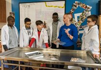 Amanda Heiser, 436th Force Support Squadron Youth Center child and youth program assistant, holds a fetal pig May 14, 2018, at the Youth Center on Dover Air Force Base, Del. Children enrolled at the Youth Center have the opportunity to dissect numerous specimens under the guidance of an instructor in the Science, Technology, Engineering and Math room. (U.S. Air Force photo by Roland Balik)
