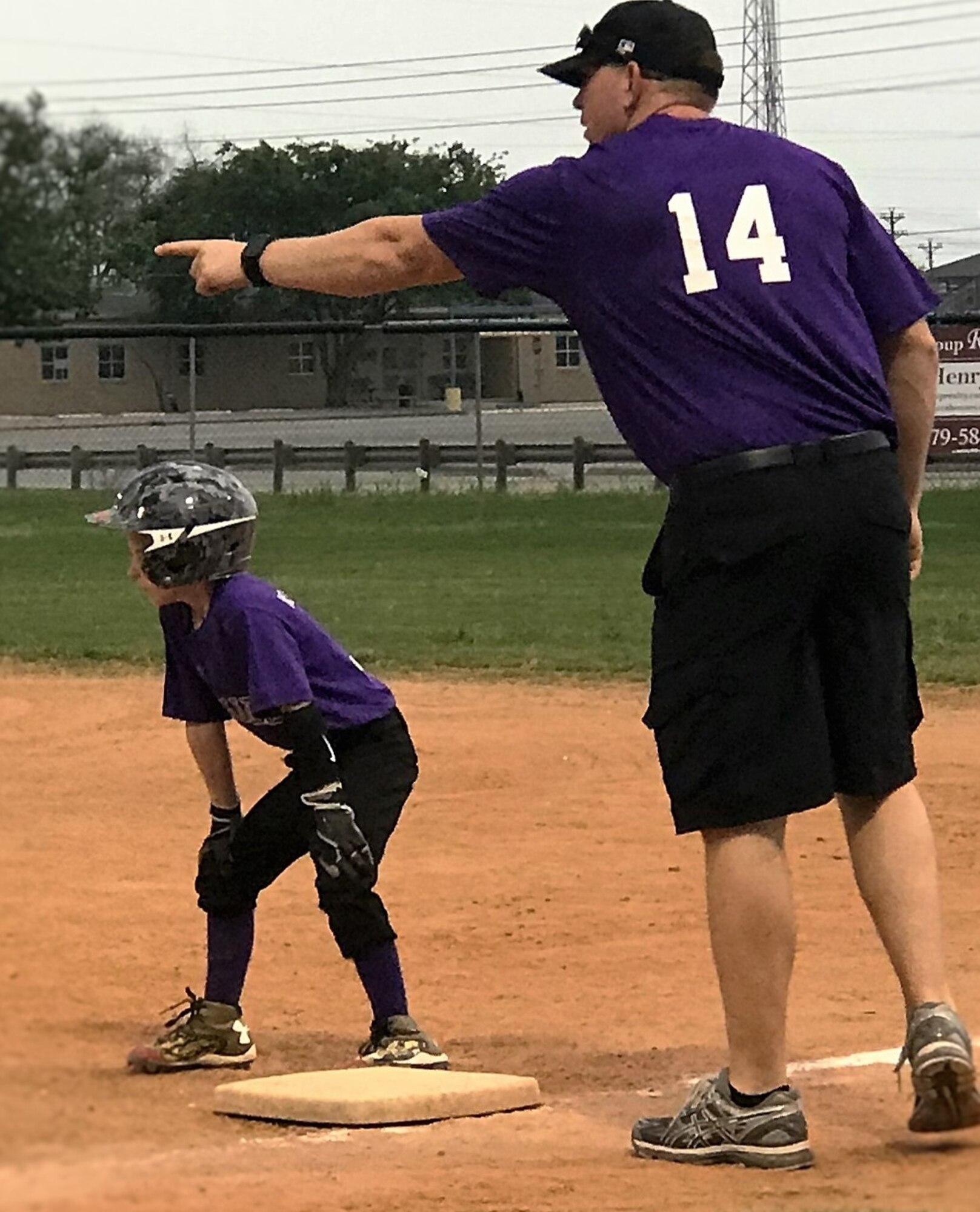 Master Sgt. Randy Alvis coaches first base during a recent youth baseball game. (U.S. Air Force photo)