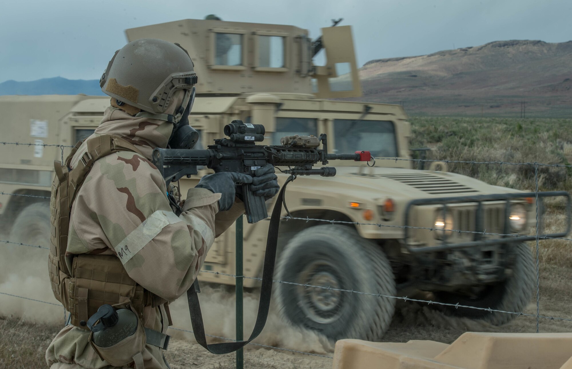 An Airman assigned to the 821st Contingency Response Group scans his sector during exercise Cerberus Strike April 30, 2018, at Amedee Army Airfield, Calif.  The contingency response element exercised their ability to execute and sustain rapid global mobility throughout California. (U.S. Air Force photo by Staff Sgt. Robert Hicks)