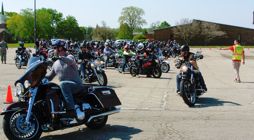 Staff Sgt. Zach Herick, Wright-Patterson Air Force Base Motorcycle Safety Day 2018 lead (right), directs more than 120 motorcycle riders as they depart on an optional 38-mile group ride as part of the event May 11.