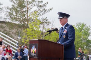 A military leader speaks from behind a podium.