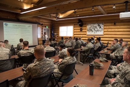 Russell Black Military Family Readiness Center director, speaks to Airman Leadership School graduates about the MFRC at Joint Base Elmendorf-Richardson, Alaska, May 10, 2018. The graduates took part in a new Pacific Air Forces-wide initiative for all ALS graduates to reinforce information obtained in Initial Supervisor Resiliency Training. At the forefront of this initiative is a bus tour the day after graduation, which offers an opportunity to see and interact with the programs and resources discussed during the course.