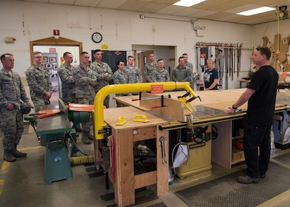 Jason Pressler Polar Express Arts and Crafts woodcraft instructor, speaks to Airman Leadership School graduates about the Woodcraft Shop at Joint Base Elmendorf-Richardson, Alaska, May 10, 2018. The graduates took part in a new Pacific Air Forces-wide initiative for all ALS graduates to reinforce information obtained in Initial Supervisor Resiliency Training. At the forefront of this initiative is a bus tour the day after graduation, which offers an opportunity to see and interact with the programs and resources discussed during the course.
