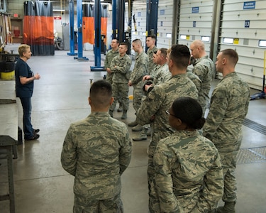 Annette Reed Polar Express Arts and Crafts director, speaks to Airman Leadership School graduates about the Auto Shop at Joint Base Elmendorf-Richardson, Alaska, May 10, 2018. The graduates took part in a new Pacific Air Forces-wide initiative for all ALS graduates to reinforce information obtained in Initial Supervisor Resiliency Training. At the forefront of this initiative is a bus tour the day after graduation, which offers an opportunity to see and interact with the programs and resources discussed during the course.