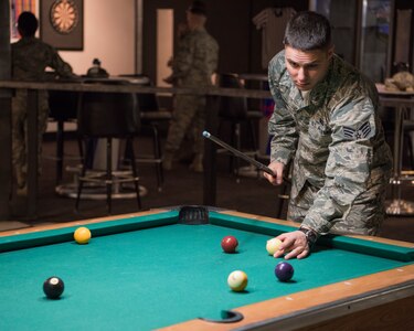 Senior Airman Michael Sadler, 673d Communication vulnerability hunt technician, plays pool at the Warrior Zone as part of an Initial Supervisor Resiliency Training bus tour at Joint Base Elmendorf-Richardson, Alaska, May 10, 2018. The tour is a new Pacific Air Forces-wide initiative for all ALS graduates, which offers an opportunity to see and interact with the programs and resources discussed during the course.