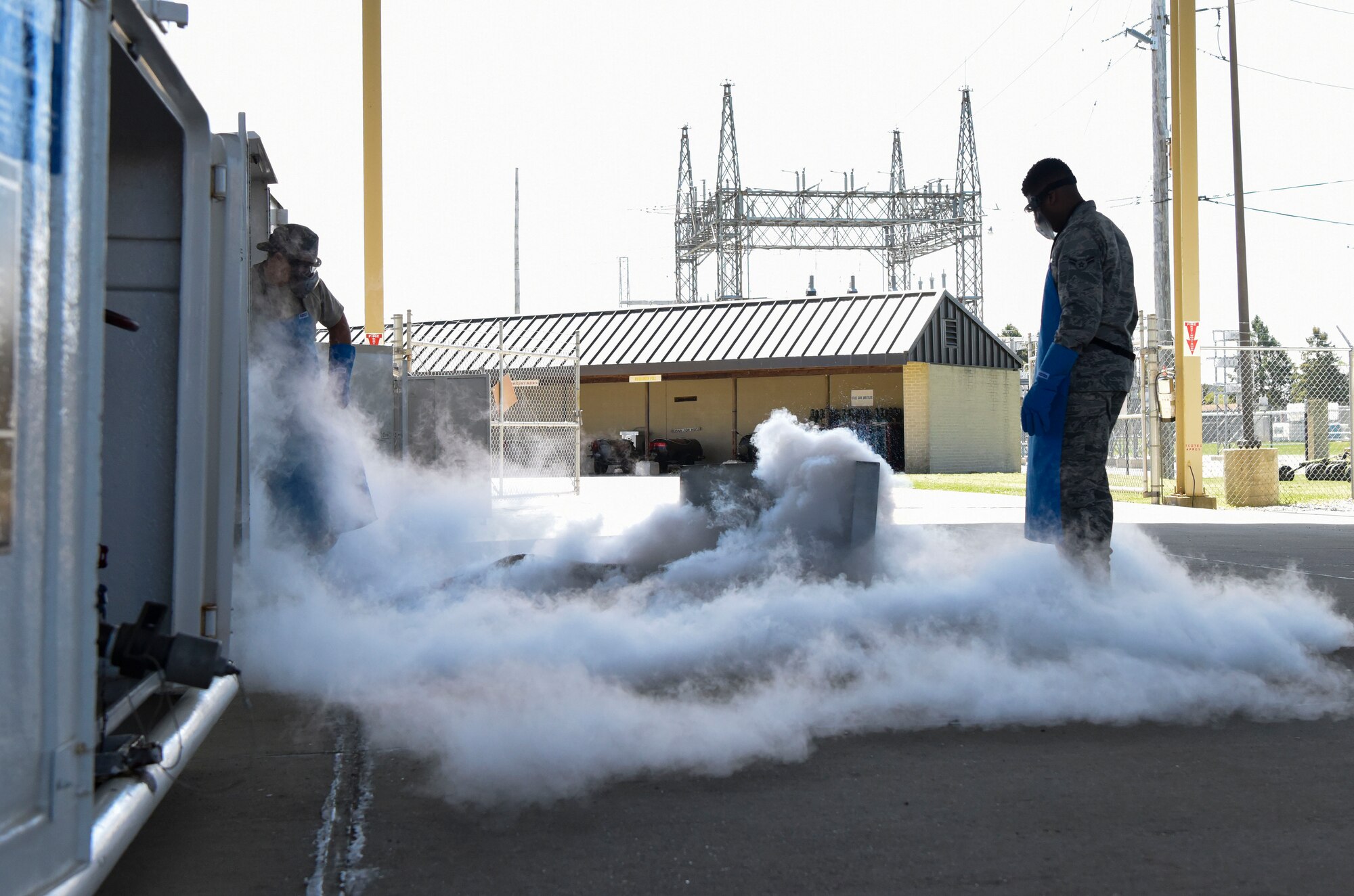 Staff Sgt. Jason Hill, 436th Logistics Readiness Squadron NCO in-charge of Fuels Facilities and Airman 1st Class Dimitrios Russell, 436th LRS cryogenics operations, perform a demonstration for an honorary commanders’ tour May 9, 2018, at Dover Air Force Base, Del. Aside from seeing the abilities of cryogenics the group also toured the installation’s fuels facilities. (U.S. Air Force photo by Airman 1st Class Zoe Wockenfuss)