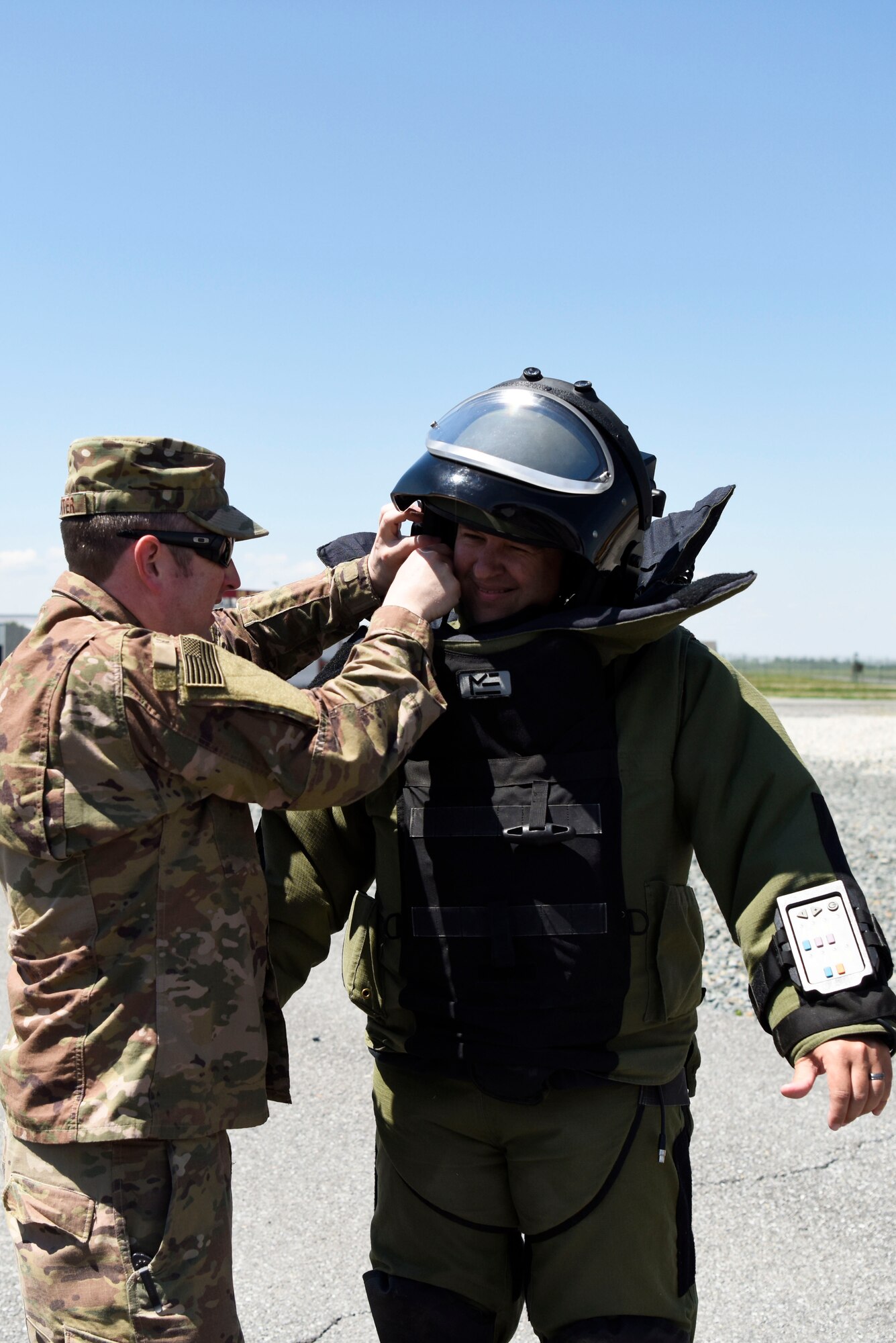 Master Sgt. Garth Muenter, 512th Civil Engineer Squadron explosive ordnance disposal technician, affixes a helmet to Allen Carter, director of business administration at Dover Motorsports, who tried on EOD protective equipment during an honorary commanders’ tour May 9, 2018, at Dover air Force Base, Del. The suit weighs about 75 pounds and limits the wearer’s dexterity. (U.S. Air Force photo by Airman 1st Class Zoe Wockenfuss)