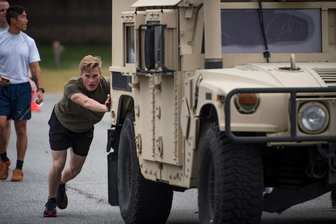 An Airman from the 822nd Base Defense Squadron pushes a Humvee during Moody’s celebration of Police Week, May 14, 2018, at Moody Air Force Base, Ga. Police Week is celebrated in May of each year and is a national effort to recognize and honor law enforcement members who have lost their lives in the line of duty. Moody’s 2018 celebration includes a security forces muster, a 5k run, a vehicle showcase with vehicles from the Valdosta Police Department and the Georgia State Patrol as well as memorial ceremonies. (U.S. Air Force photo by Staff Sgt. Ryan Callaghan)