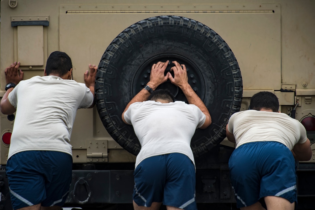 Airmen from the 23d Security Forces Squadron push a Humvee during Moody’s celebration of Police Week, May 14, 2018, at Moody Air Force Base, Ga. Police Week is celebrated in May of each year and is a national effort to recognize and honor law enforcement members who have lost their lives in the line of duty. Moody’s 2018 celebration includes a security forces muster, a 5k run, a vehicle showcase with vehicles from the Valdosta Police Department and the Georgia State Patrol as well as memorial ceremonies. (U.S. Air Force photo by Staff Sgt. Ryan Callaghan)