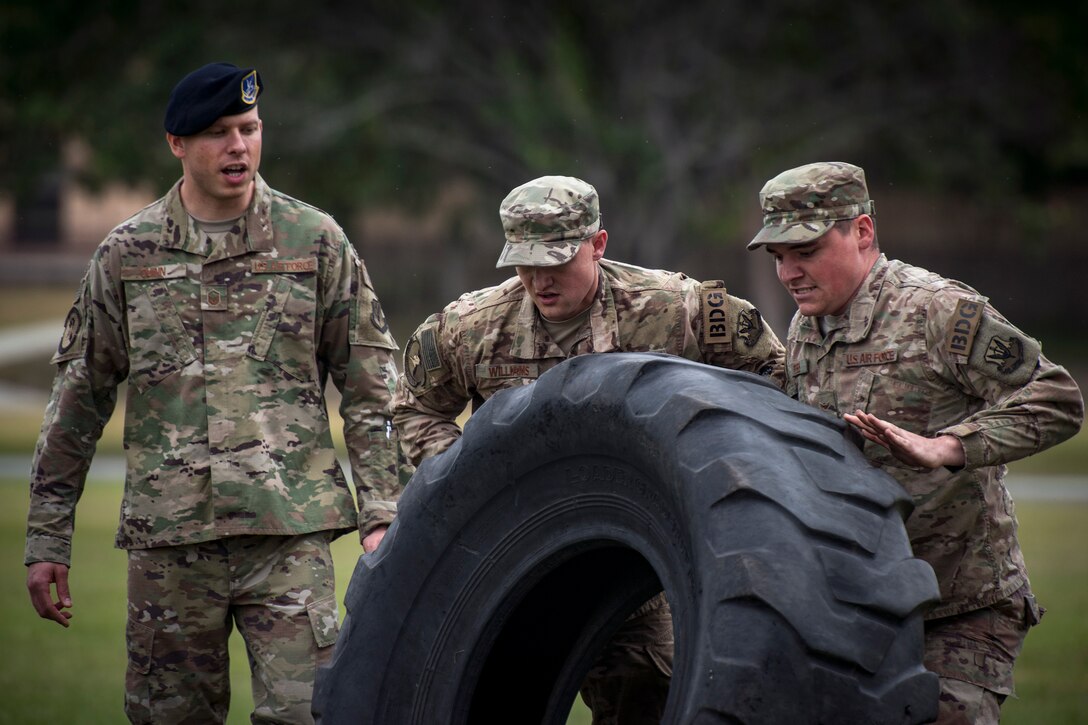 Airmen from the 824th Base Defense Squadron flip a tire during Moody’s celebration of Police Week, May 14, 2018, at Moody Air Force Base, Ga. Police Week is celebrated in May of each year and is a national effort to recognize and honor law enforcement members who have lost their lives in the line of duty. Moody’s 2018 celebration includes a security forces muster, a 5k run, a vehicle showcase with vehicles from the Valdosta Police Department and the Georgia State Patrol as well as memorial ceremonies. (U.S. Air Force photo by Staff Sgt. Ryan Callaghan)