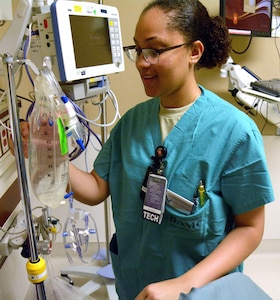 Airman 1st Class Emoni Covington, a medical technician, prepares an IV bag on the pre-operation unit at Brooke Army Medical Center May 14. Covington is an Air Force 4N0, which is the next enlisted medical series to take part in the Medic Utilization Program at BAMC.