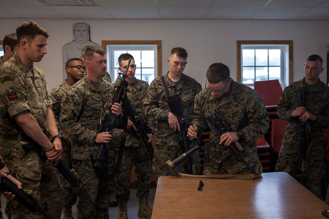 U.S. Marine Sgt. Derek R. Rush, marksmanship coach with Headquarters and Service Company, 6th Engineer Support Battalion, 4th Marine Logistics Group, Marine Forces Reserve, teaches the commandos with 131 Commando Squadron Royal Engineers, British army, how to properly break down their rifles during exercise Red Dagger at Fort Indiantown Gap, Pa., May 13, 2018.