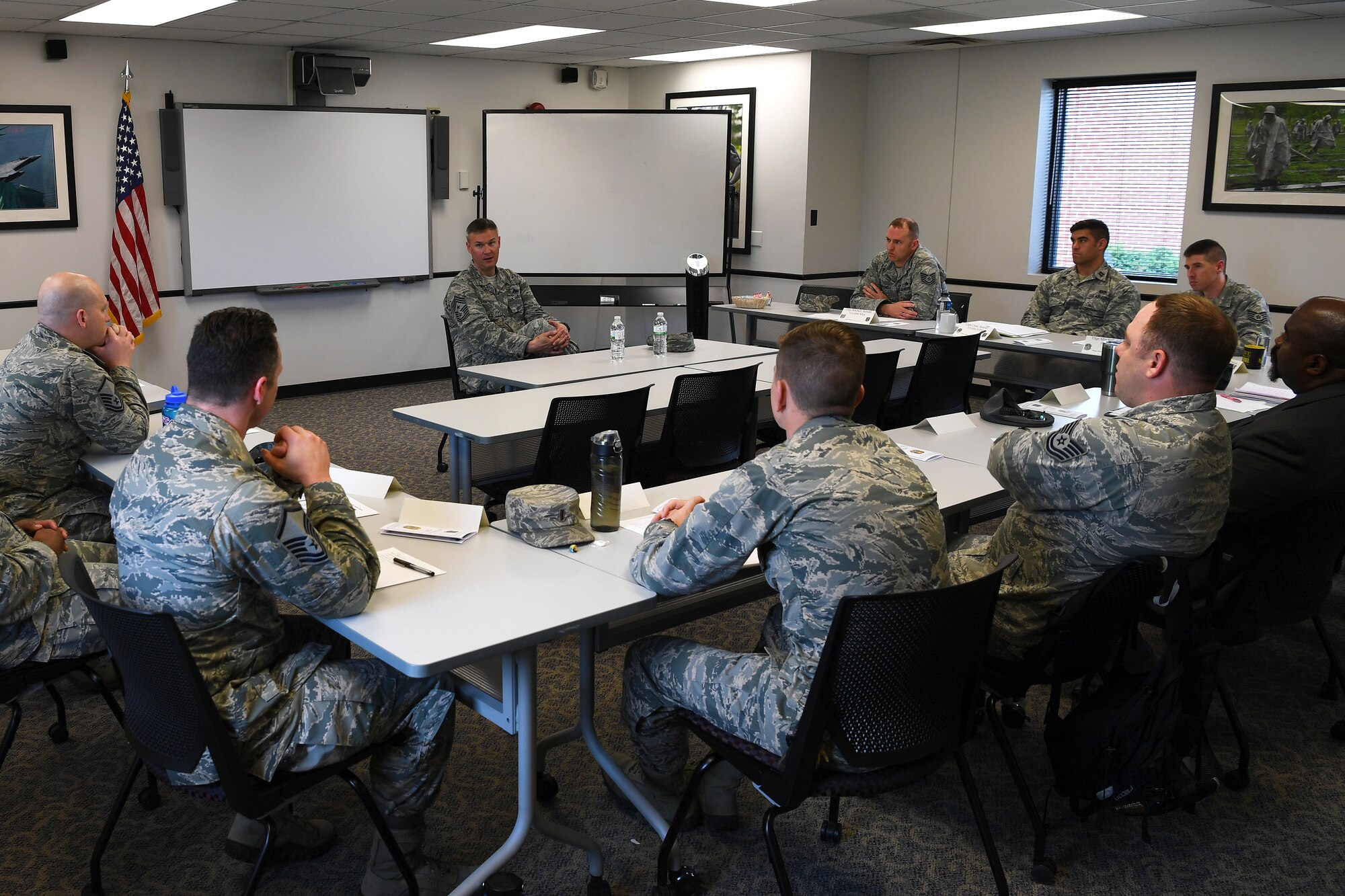Chief Master Sgt. Brian Thomas, 319th Air Base Wing command chief, center, speaks to enlisted service members, officers and civilian employees in current or future leadership positions during a course focused on leadership May 8, 2018, on Grand Forks Air Force Base, North Dakota. The three-day Flight Leader Course is the first of its kind to be offered at Grand Forks AFB, and is designed to inform and expose class participants to important information which will help them succeed in their roles as leaders. (U.S. Air Force photo by Airman 1st Class Elora J. Martinez)